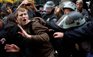 An Occupy Wall Street protestor is grabbed by police as he tries to escape a scuffle in Zuccotti Park, Thursday, Nov. 17, 2011, in New York. Two days after the encampment that sparked the global Occupy movement was cleared by authorities, demonstrators marched through the financial district and promised mass gatherings in other cities. (AP Photo/John Minchillo)
